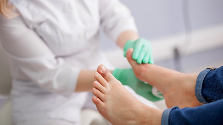 nurse treating patient foot